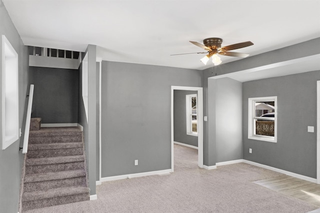 spare room with ceiling fan and plenty of natural light