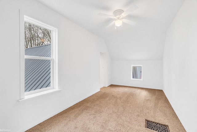 bonus room with ceiling fan, lofted ceiling, and light carpet