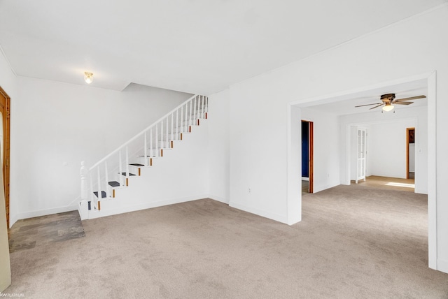 unfurnished living room with carpet floors and ceiling fan