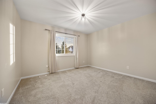 spare room with light colored carpet