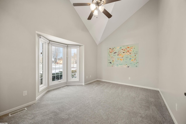 unfurnished room featuring ceiling fan, carpet floors, and high vaulted ceiling