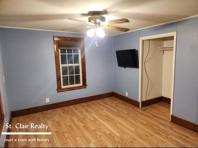 unfurnished bedroom with crown molding, a closet, ceiling fan, and light wood-type flooring