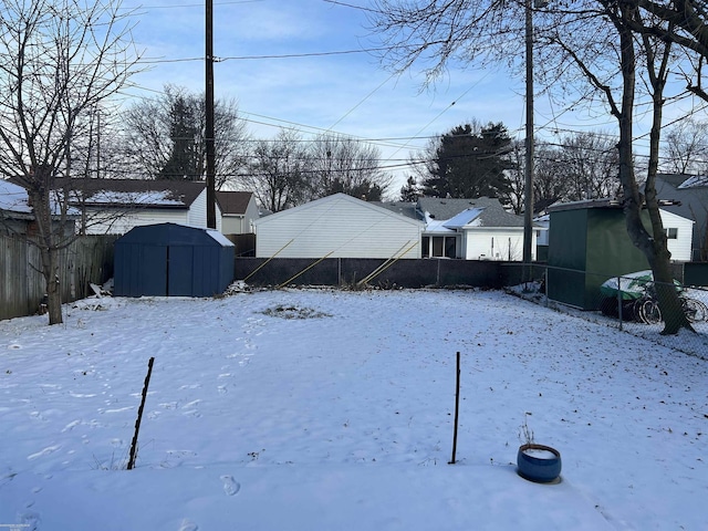 snowy yard with a storage unit