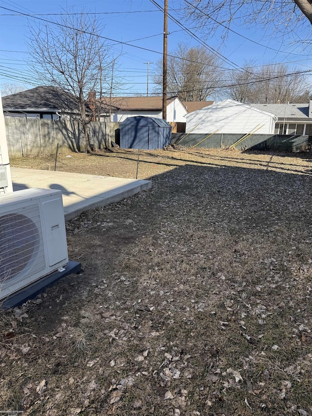 view of yard with ac unit and fence