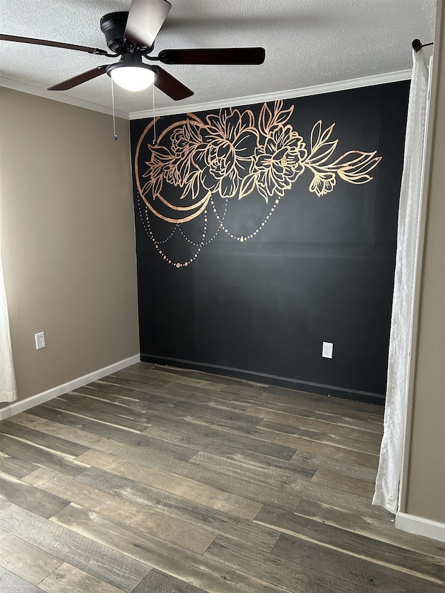 unfurnished room with crown molding, dark wood-type flooring, and a textured ceiling