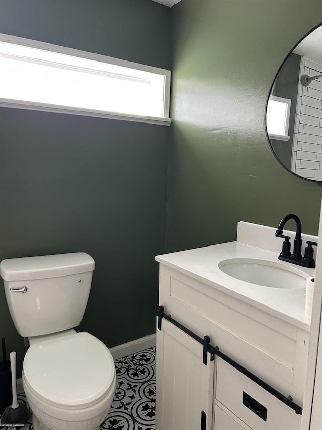 bathroom with vanity, toilet, and tile patterned flooring