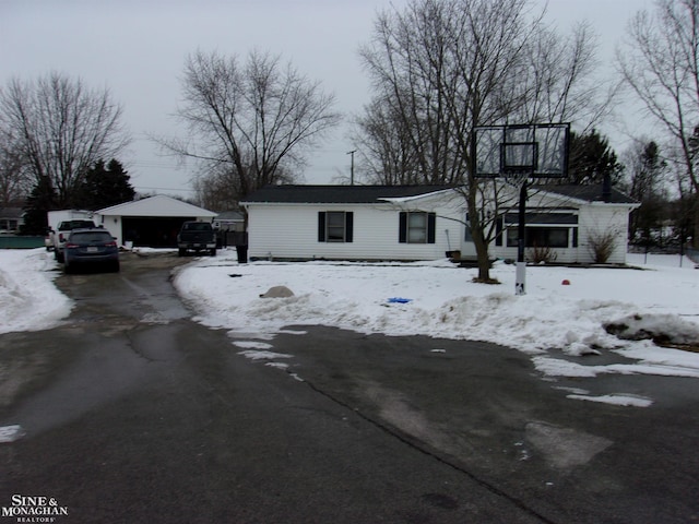 view of front of property featuring a garage and an outbuilding