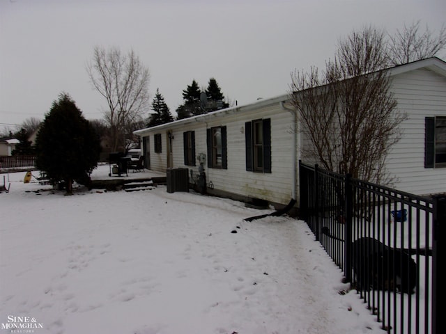 view of snowy exterior with central air condition unit