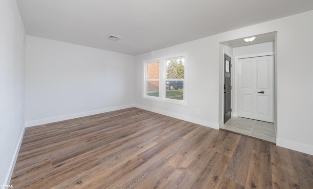 spare room featuring hardwood / wood-style flooring