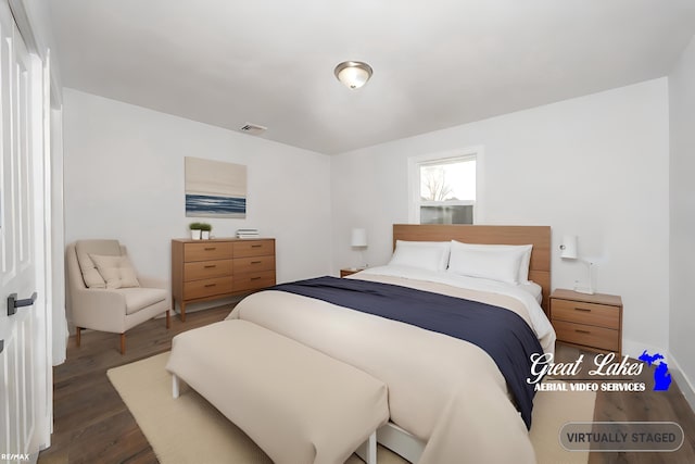 bedroom with dark hardwood / wood-style flooring