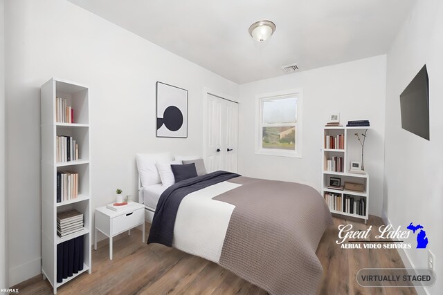 bedroom featuring hardwood / wood-style flooring and a closet