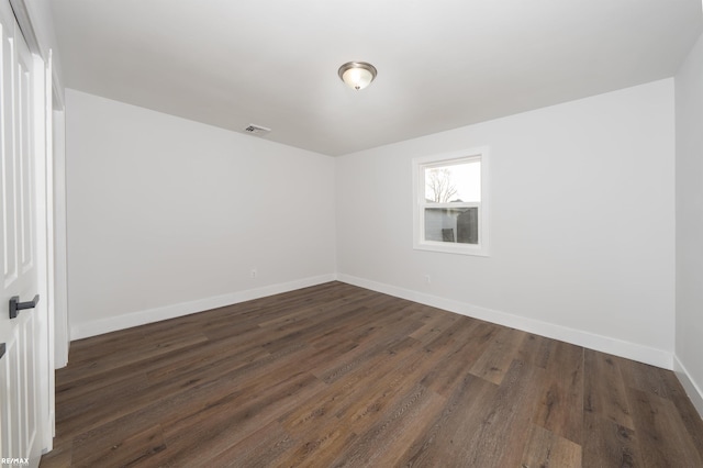 spare room featuring dark hardwood / wood-style floors