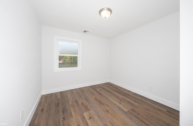 empty room featuring dark wood-type flooring