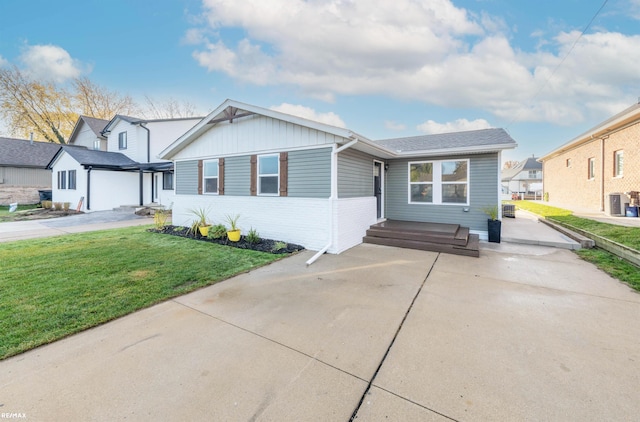 view of front of house featuring a front yard and central air condition unit