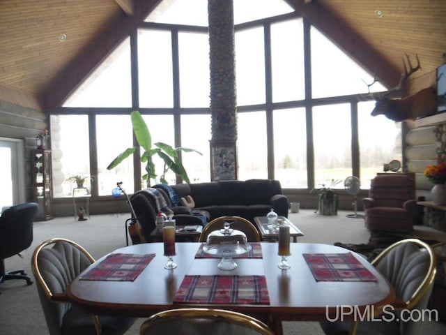 dining space featuring carpet, a wealth of natural light, and wood ceiling