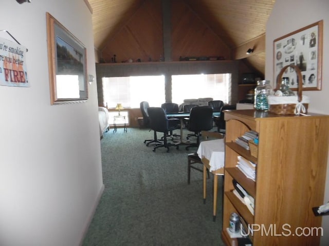 carpeted home office featuring lofted ceiling