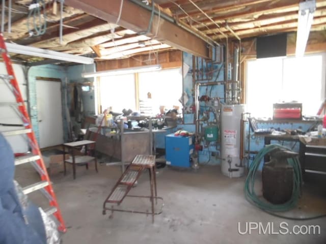 basement featuring a workshop area and water heater