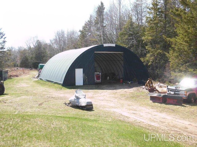 view of outbuilding featuring a yard