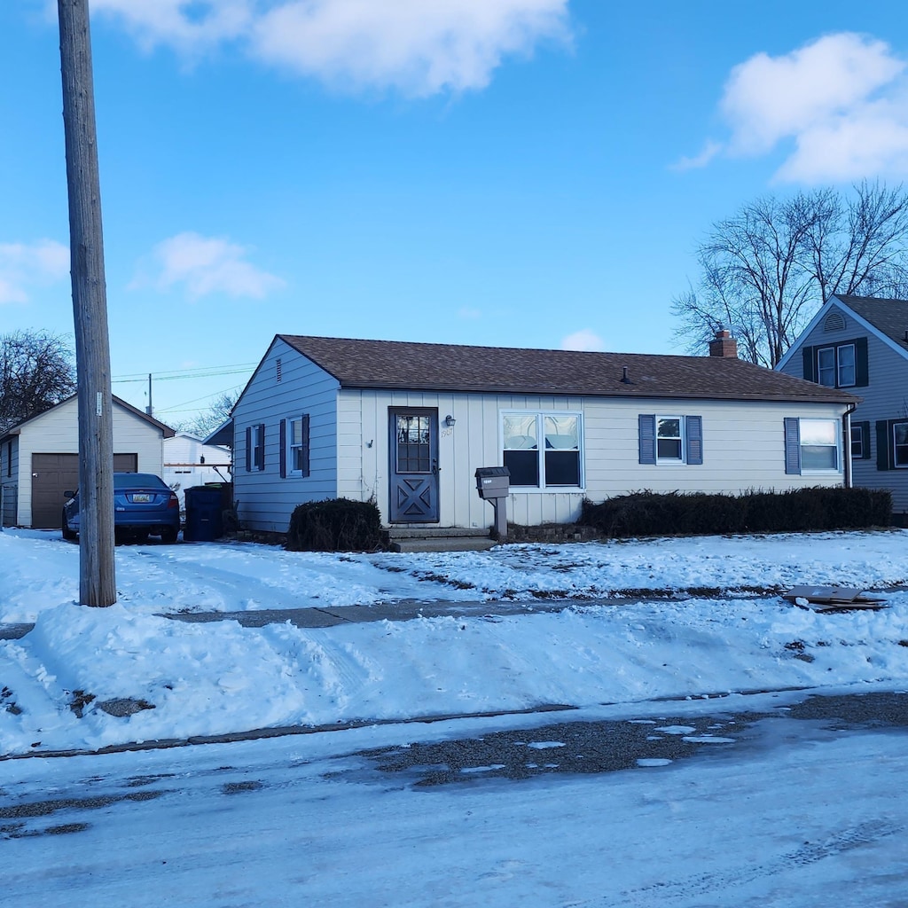 view of front facade featuring a garage and an outdoor structure