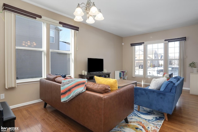 living room with an inviting chandelier and hardwood / wood-style floors