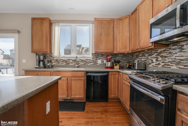 kitchen featuring light hardwood / wood-style flooring, sink, plenty of natural light, and stainless steel appliances