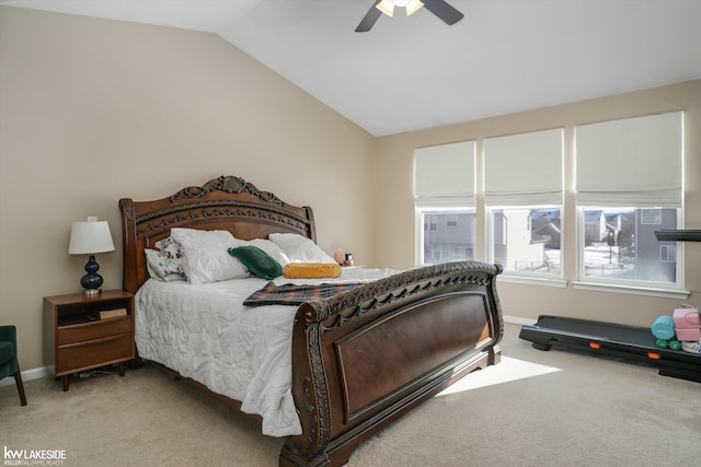 bedroom featuring vaulted ceiling, light colored carpet, and ceiling fan