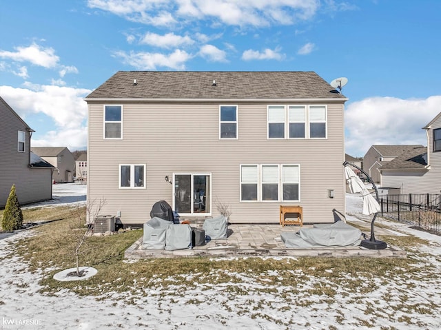 snow covered property featuring a patio and central air condition unit