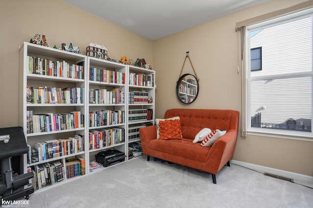 sitting room featuring a wealth of natural light and light colored carpet