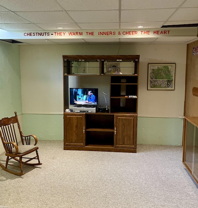 carpeted living room with a drop ceiling