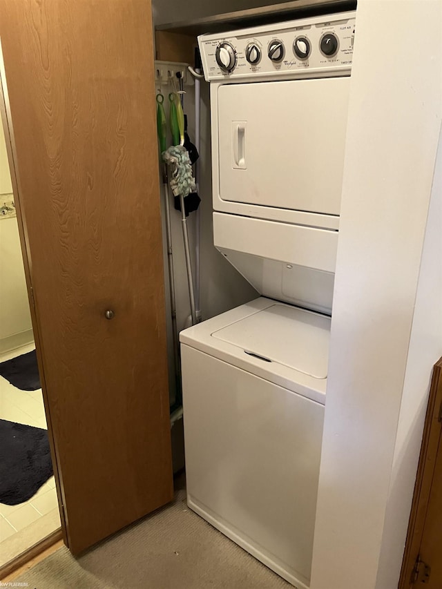 laundry area with stacked washer / dryer