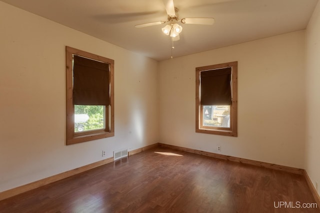 spare room with dark hardwood / wood-style floors and ceiling fan