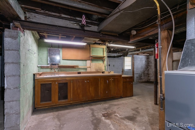 basement with sink and heating unit