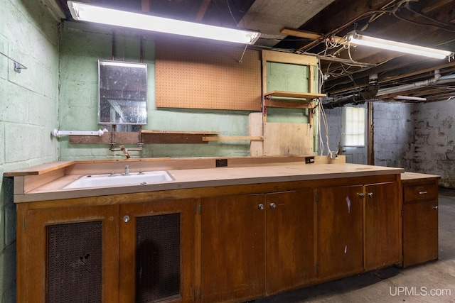 kitchen with sink and concrete flooring