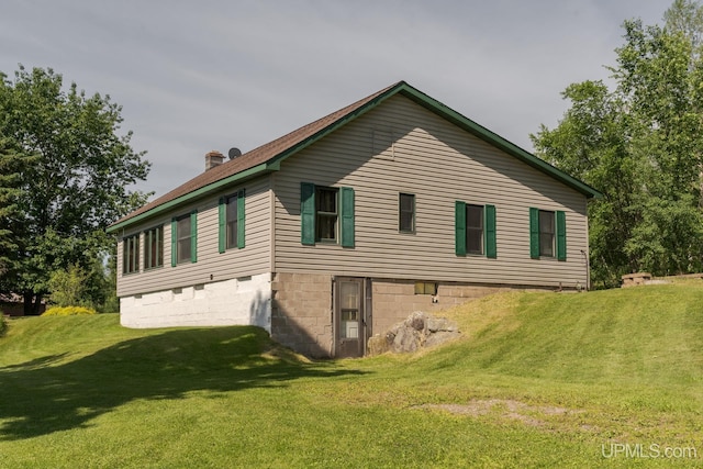 view of side of home featuring a yard