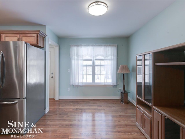 kitchen featuring dark hardwood / wood-style floors and stainless steel refrigerator