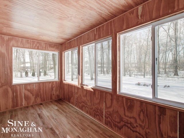 unfurnished sunroom featuring wood ceiling