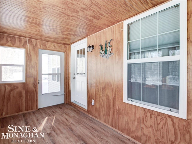 unfurnished sunroom featuring wooden ceiling