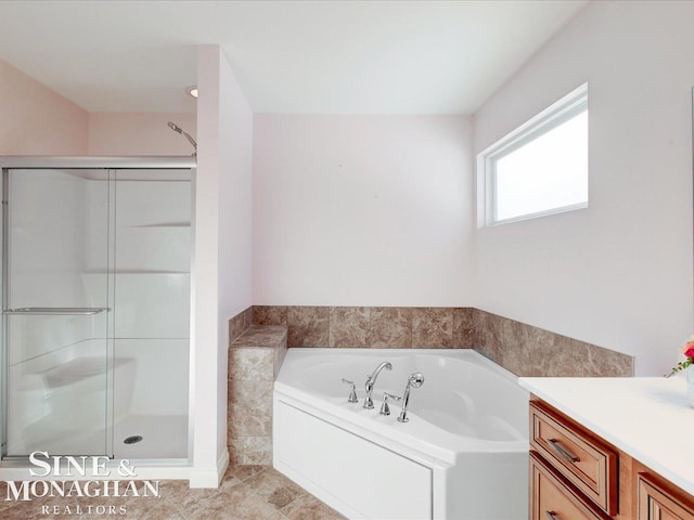 bathroom featuring vanity and shower with separate bathtub