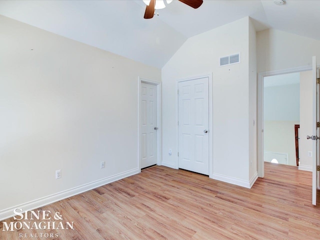 unfurnished bedroom featuring vaulted ceiling, ceiling fan, and light wood-type flooring