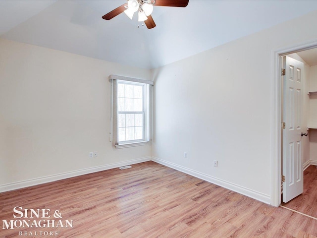 empty room featuring ceiling fan, vaulted ceiling, and light hardwood / wood-style flooring