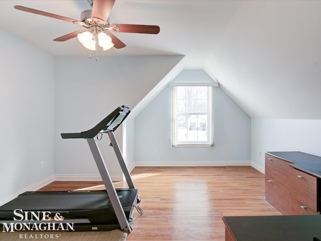 exercise area with ceiling fan, lofted ceiling, and light hardwood / wood-style flooring