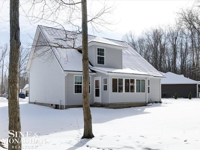 view of snow covered rear of property