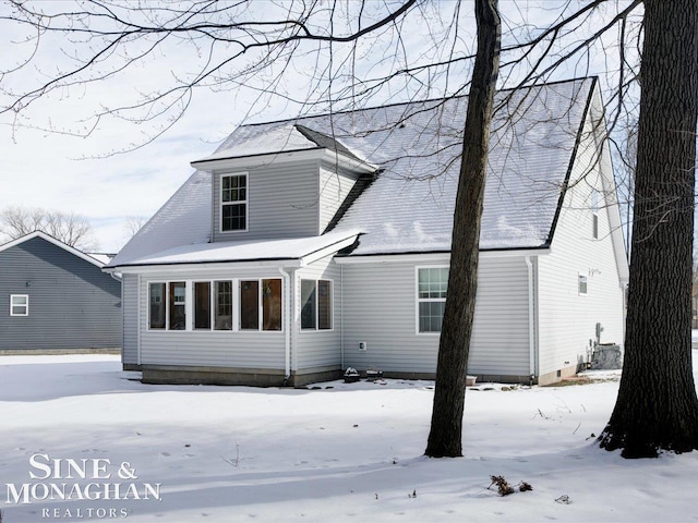 view of snow covered back of property