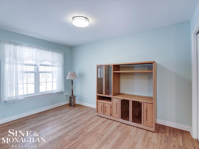 unfurnished living room with light hardwood / wood-style flooring