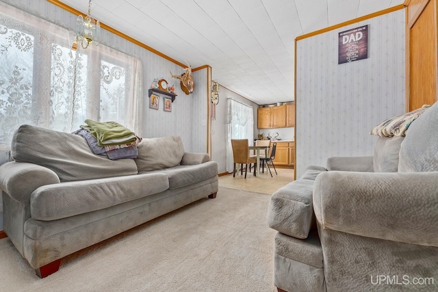 living room with crown molding and light colored carpet