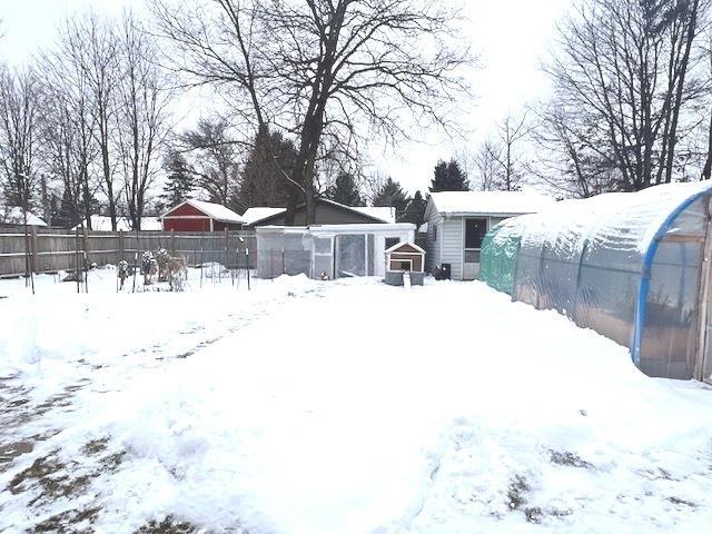 snowy yard with an outdoor structure