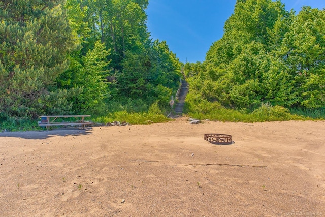 surrounding community featuring a fire pit