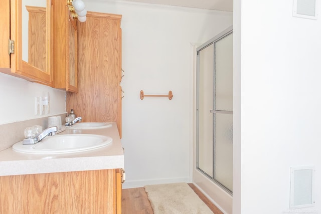 bathroom with walk in shower and vanity