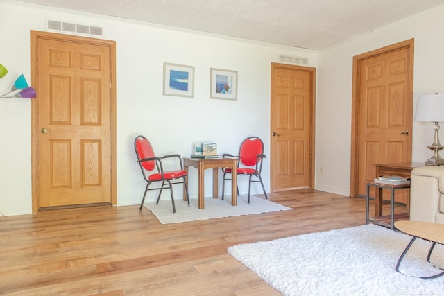 sitting room featuring light wood-type flooring