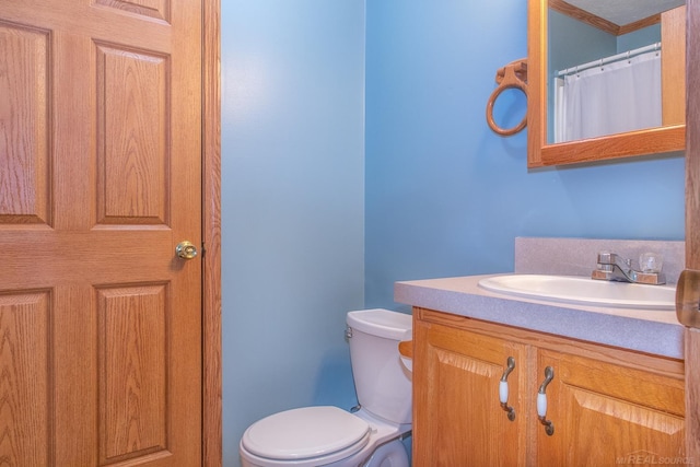 bathroom featuring vanity and toilet